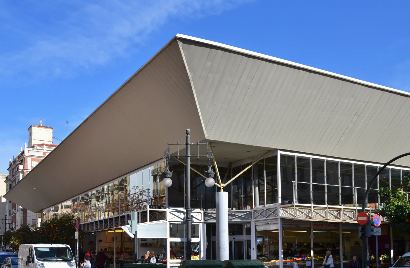 Exterior of the market building in Placa de Jesus with a large angled roof canopy.