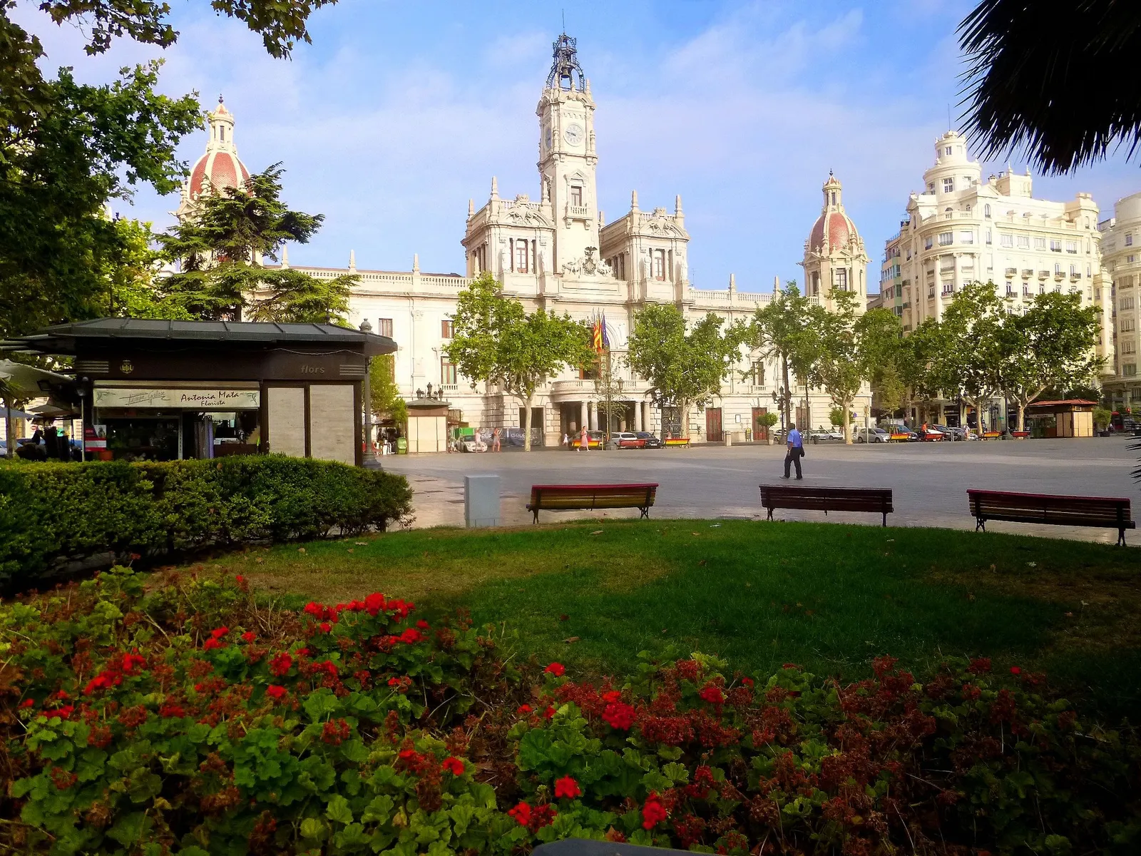 Plaza del Ayuntamiento in Valencia with the town hall tower and a flower bed