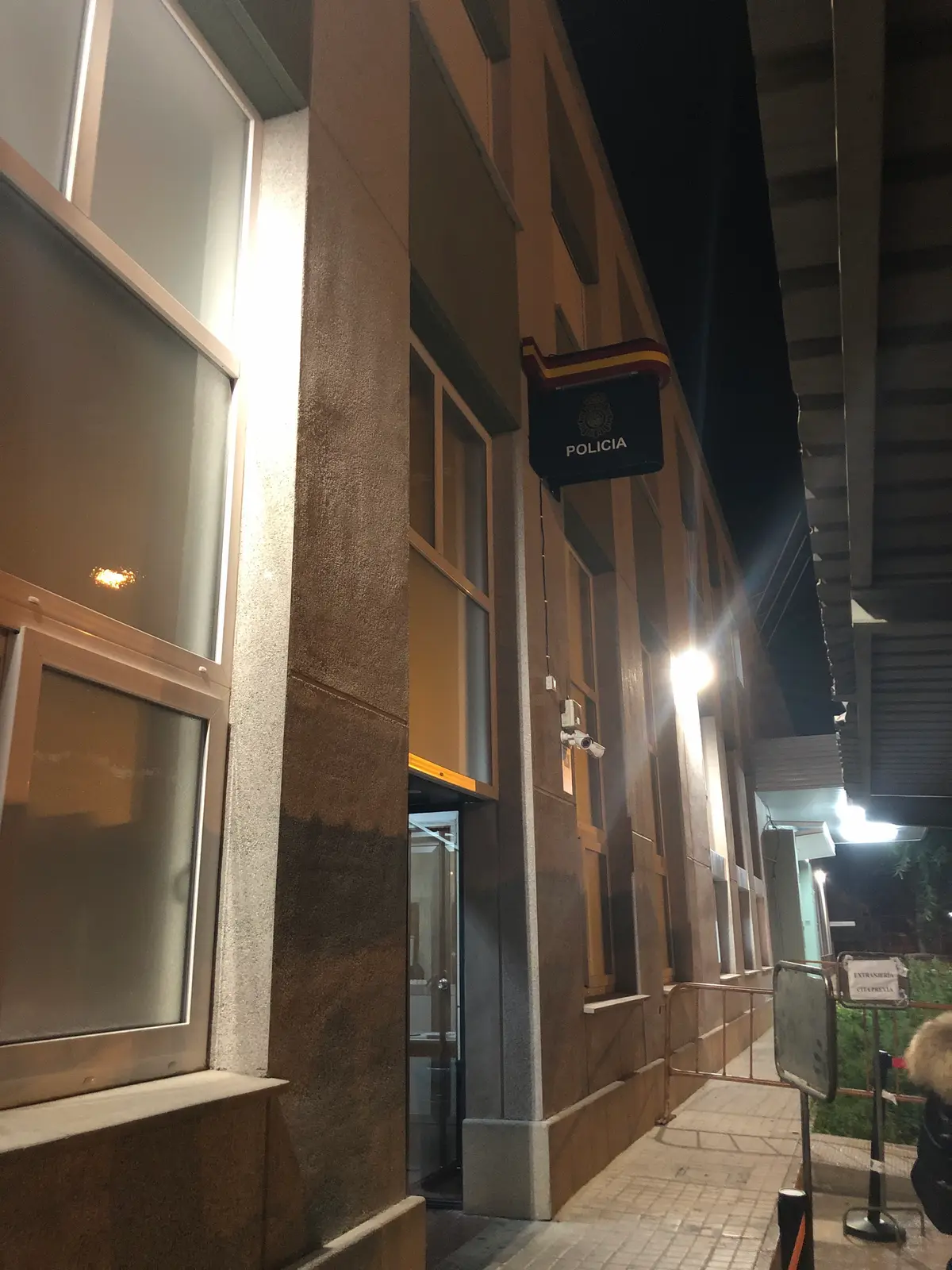 Police sign above the entrance of a building at night