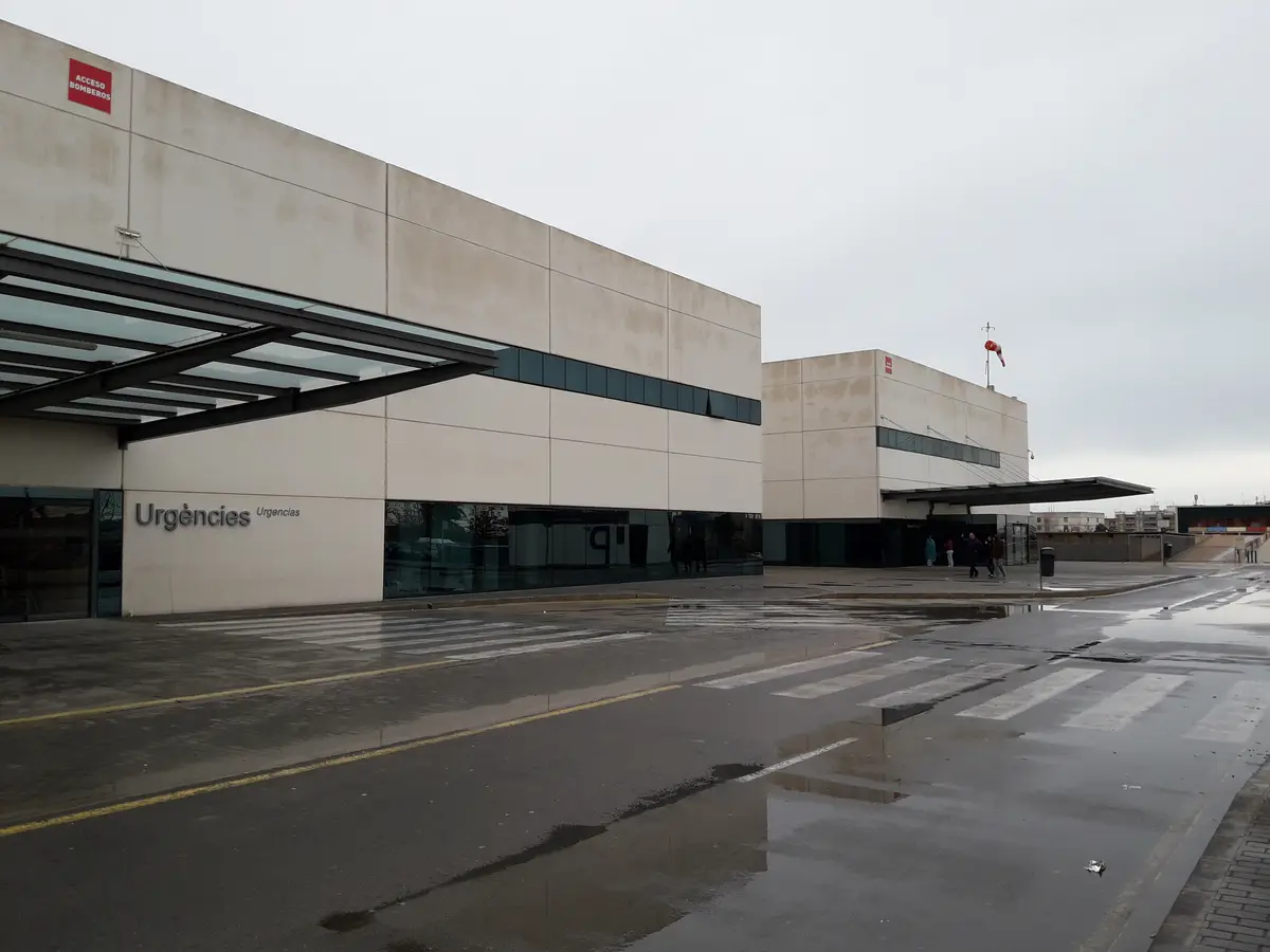 Hospital building with an emergency department sign above a wide covered entrance