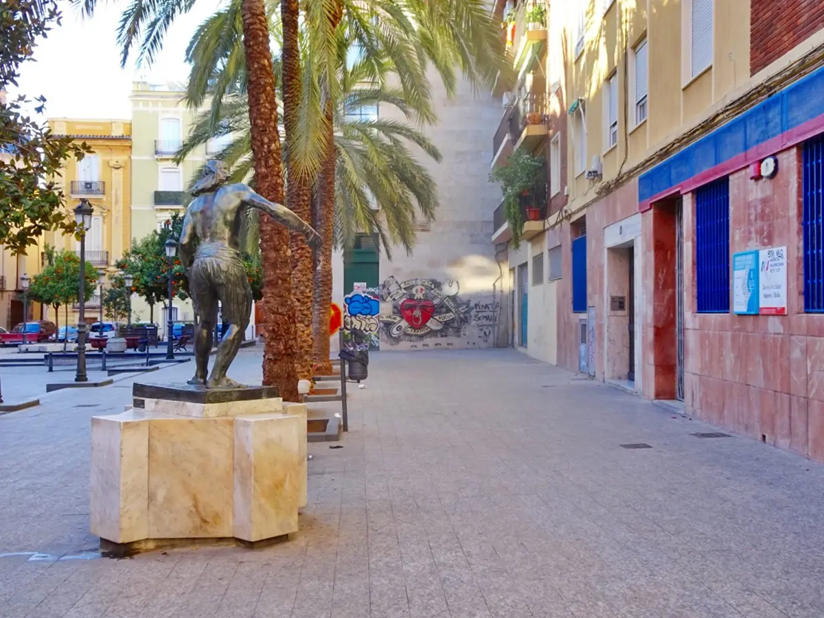 Small square with a bronze statue and the health centre building on the right