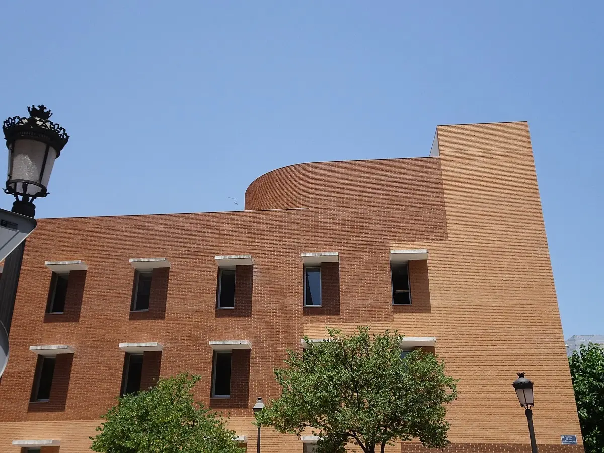 Brick health centre building with curved walls and small windows