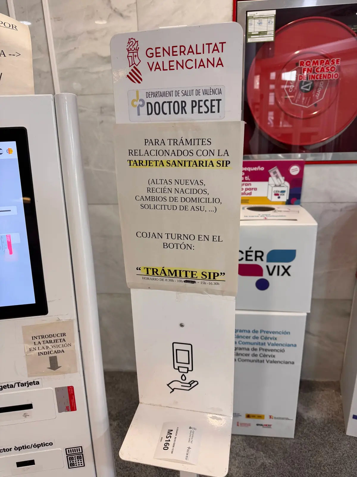 Notice beside a check-in kiosk at a health centre pointing SIP card requests to a button on the screen