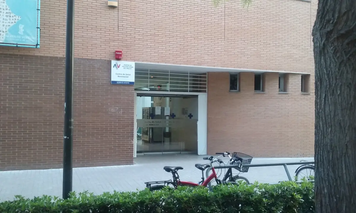 Brick health centre entrance with glass doors and a bicycle parked outside